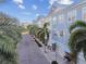 Street view of the residential neighborhood with colorful townhomes and mature palm trees at 6007 Anchorage Way, St Petersburg, FL 33712