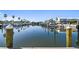 Scenic water view of the marina lined with boats and palm trees under a blue sky at 6007 Anchorage Way, St Petersburg, FL 33712