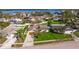 Aerial view of a home featuring a manicured lawn, mature trees, and a driveway at 6101 Tanglewood Ne Dr, St Petersburg, FL 33703