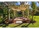 Outdoor pergola with brick patio and shaded seating area at 632 Royal Dornock Ct, Tarpon Springs, FL 34688