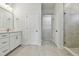 Modern bathroom featuring double vanity with quartz countertops and walk-in shower at 7213 Sutton Ln, Sarasota, FL 34240