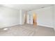 Large primary bedroom with neutral carpet and multiple doors to closet and bath at 7213 Sutton Ln, Sarasota, FL 34240