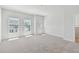 Bright bedroom with neutral carpet, large windows, and ample natural light at 7213 Sutton Ln, Sarasota, FL 34240