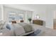 Bright bedroom boasts large windows, a decorative rug, and stylish furnishings at 7213 Sutton Ln, Sarasota, FL 34240