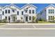 New townhome with white exterior, black accents, and a well-maintained front yard with a black metal fence at 7213 Sutton Ln, Sarasota, FL 34240
