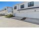 White townhome complex boasts attached garage and modern design at 7213 Sutton Ln, Sarasota, FL 34240