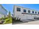 New construction townhome with attached garage and manicured landscaping at 7213 Sutton Ln, Sarasota, FL 34240