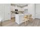 Modern kitchen features white cabinets, stainless steel appliances, and a center island with bar seating at 7213 Sutton Ln, Sarasota, FL 34240