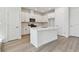 Contemporary kitchen featuring stainless appliances, white cabinets and a large island at 7213 Sutton Ln, Sarasota, FL 34240
