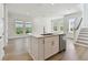 Bright, white kitchen island featuring stainless steel appliances, sink and quartz countertop at 7213 Sutton Ln, Sarasota, FL 34240