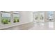 Inviting living room bathed in natural light, showcasing sleek floors and an airy ambiance at 7213 Sutton Ln, Sarasota, FL 34240