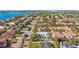 An amazing aerial view of a residential neighborhood close to the ocean featuring manicured lawns and beautiful home exteriors at 725 Monte Cristo Blvd, Tierra Verde, FL 33715