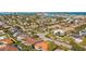 Beautiful aerial view of homes in a vibrant residential community, showcasing lush landscaping, palm trees, and lovely water views at 725 Monte Cristo Blvd, Tierra Verde, FL 33715