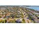 Lovely aerial view of a Gathering-friendly residential community by the water with mature trees, landscaping, and manicured lawns at 725 Monte Cristo Blvd, Tierra Verde, FL 33715