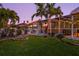 Beautiful backyard with lush greenery, a charming firepit, and a screened lanai for outdoor living at 725 Monte Cristo Blvd, Tierra Verde, FL 33715
