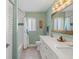 Bathroom featuring double sinks, marble countertops, and tub with shower at 725 Monte Cristo Blvd, Tierra Verde, FL 33715
