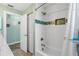 Bathroom showing the shower with white tile and a decorative blue tile accent at 725 Monte Cristo Blvd, Tierra Verde, FL 33715