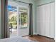 Bedroom view of an outdoor patio and pool area through sliding glass doors at 725 Monte Cristo Blvd, Tierra Verde, FL 33715