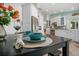 Cozy dining table set for two, with a view into the bright and modern kitchen at 725 Monte Cristo Blvd, Tierra Verde, FL 33715