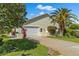 Charming home features a well-manicured lawn, attached garage and a classic driveway at 725 Monte Cristo Blvd, Tierra Verde, FL 33715
