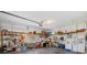 Spacious garage featuring ample storage, shelving, and a work area with a large open floor at 725 Monte Cristo Blvd, Tierra Verde, FL 33715