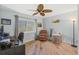 Bright home office featuring a ceiling fan, a window, hardwood floors and comfortable seating at 725 Monte Cristo Blvd, Tierra Verde, FL 33715