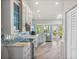 Well-lit kitchen featuring custom white cabinetry, stainless steel appliances and tile backsplash at 725 Monte Cristo Blvd, Tierra Verde, FL 33715