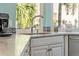 Stylish kitchen sink with white marble countertop and tile backsplash at 725 Monte Cristo Blvd, Tierra Verde, FL 33715