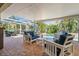 Lanai with patio furniture, seating, and a view of the pool and landscaping at 725 Monte Cristo Blvd, Tierra Verde, FL 33715