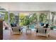 Covered lanai with seating area and views of the pool with waterfall feature at 725 Monte Cristo Blvd, Tierra Verde, FL 33715