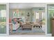 Living room with water views, seating, and access to the outdoor lanai at 725 Monte Cristo Blvd, Tierra Verde, FL 33715