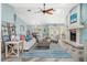 Bright living room featuring wood floors, a fireplace, coastal decor and plenty of seating at 725 Monte Cristo Blvd, Tierra Verde, FL 33715