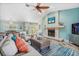 Spacious living room with a fireplace, comfortable seating, and a view of the dining area at 725 Monte Cristo Blvd, Tierra Verde, FL 33715