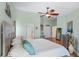 Spacious primary bedroom with ceiling fan, ensuite access, and a cool color palette at 725 Monte Cristo Blvd, Tierra Verde, FL 33715