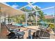 Relaxing screened patio with comfortable seating overlooking the beautiful pool and lush landscaping at 725 Monte Cristo Blvd, Tierra Verde, FL 33715