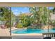 Captivating pool with a rock waterfall feature, surrounded by tropical landscaping and comfortable seating at 725 Monte Cristo Blvd, Tierra Verde, FL 33715