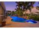 Expansive backyard featuring a pool, spa, rock waterfall, lush landscaping, and comfortable seating areas at 725 Monte Cristo Blvd, Tierra Verde, FL 33715