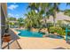 Backyard view of a stunning pool with spa and lush landscaping, creating a private oasis at 725 Monte Cristo Blvd, Tierra Verde, FL 33715