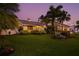 Beautifully landscaped backyard with lush greenery offering privacy and curb appeal at 725 Monte Cristo Blvd, Tierra Verde, FL 33715