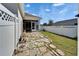Backyard featuring a screen enclosed patio, stone path, and white vinyl fence at 729 Winterside Dr, Apollo Beach, FL 33572