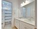 Bathroom with double sink vanity, quartz counters, and a shower-tub combo at 729 Winterside Dr, Apollo Beach, FL 33572