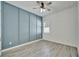 Bedroom featuring gray wood-look floors, a paneled accent wall, and modern ceiling fan at 729 Winterside Dr, Apollo Beach, FL 33572