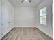 Bright bedroom features wood-look floors, a window with plantation shutters, and a closet at 729 Winterside Dr, Apollo Beach, FL 33572
