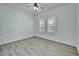 Bedroom featuring wood-look floors, plantation shutters, and lots of natural light at 729 Winterside Dr, Apollo Beach, FL 33572