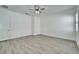 Spacious bedroom with neutral walls, modern ceiling fan, and light gray wood-look flooring at 729 Winterside Dr, Apollo Beach, FL 33572