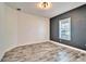 Bedroom featuring wood-look tile floors, two-tone paint, and a window with blinds at 729 Winterside Dr, Apollo Beach, FL 33572