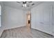 Bedroom features wood-look floors, closet, and a glimpse into the ensuite bathroom at 729 Winterside Dr, Apollo Beach, FL 33572