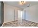Bedroom featuring wood-look tile floors, neutral paint, and an open door to another room at 729 Winterside Dr, Apollo Beach, FL 33572