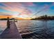 Picturesque view from a wooden dock, overlooking a tranquil lake at sunset with colorful skies at 729 Winterside Dr, Apollo Beach, FL 33572