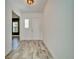 Light and bright entryway with wood-look tile floors, and a modern light fixture at 729 Winterside Dr, Apollo Beach, FL 33572
